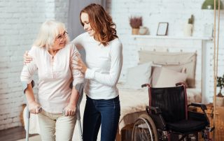 Pleasant,Caring,Woman,Helping,With,Rehabilitation,Her,Disabled,Grandmother