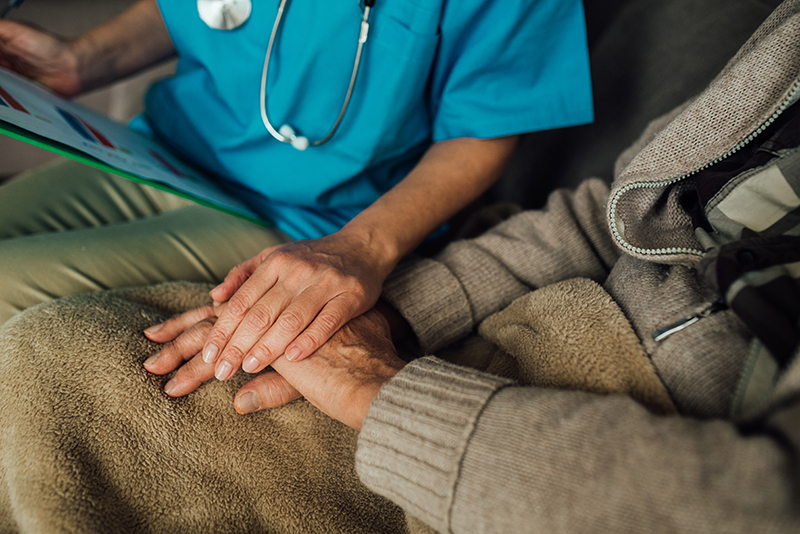 nurse holding senior womans hand nurse holding senior womans hand