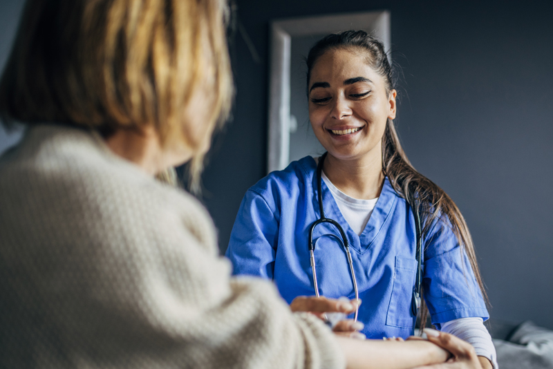 nurse smile with stethescope with senior woman
